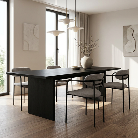 Modern dining room with a black table and gray chairs in a bright room.
