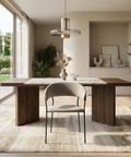 Modern dining room with wooden table, chair, and large windows.