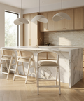 Modern kitchen with marble island and wooden stools