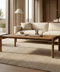 Modern living room with a beige sofa, wooden coffee table, and decorative items.
