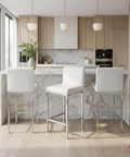 Modern kitchen with marble island and white bar stools