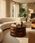 Cozy living room with a beige sectional sofa, wooden coffee table, and stone fireplace.