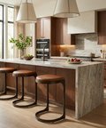 Modern kitchen with marble island, wooden stools, and stainless steel appliances.