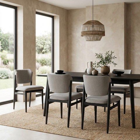 Dining room with a dark wooden table and gray chairs in a modern interior setting.