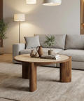 Modern living room with a gray sofa, wooden coffee table, and decorative items.