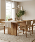 Dining room with wooden table and chairs in a bright room.