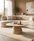Modern living room with a beige sectional sofa, wooden coffee table, and decorative elements.