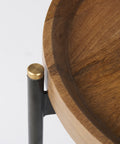Wooden table with a black metal leg and gold accent on a white background