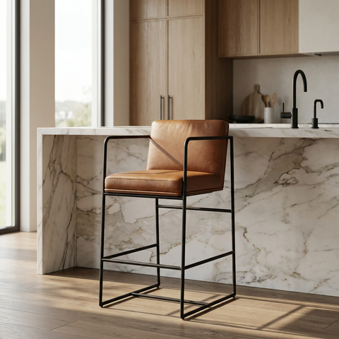 Brown leather bar stool in a modern kitchen with marble countertop and wooden cabinets.