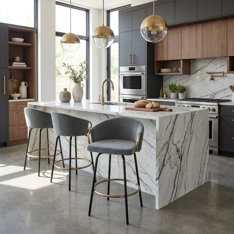 Modern kitchen with marble island, bar stools, and stainless steel appliances.