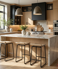 Modern kitchen with marble island, stools, and stainless steel appliances.
