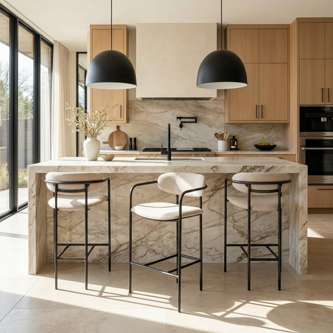 Modern kitchen with marble island, bar stools, and wooden cabinets.