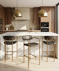 Modern kitchen with marble island, bar stools, and wooden cabinets.