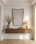 Modern interior with a wooden console table, mirror, and lamp.