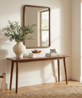 Wooden console table with decorative items in a bright room