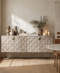 Decorative sideboard with textured design in a room with a table and chairs.