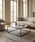 Modern living room with a beige sofa, armchair, and coffee table.
