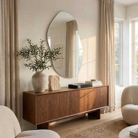 Wooden sideboard with decorative items in a living room setting