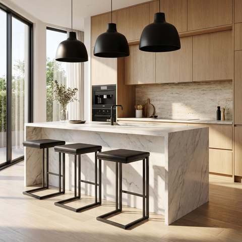 Modern kitchen with marble island, black stools, and pendant lights.