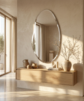 Modern interior with a wooden console table and oval mirror in a bright room.
