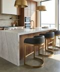 Modern kitchen with marble island and gold bar stools