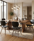 Modern dining room with wooden table and black chairs near large windows.