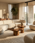 Modern living room with beige sofa, wooden coffee table, and large windows.