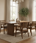 Dining room with wooden table and chairs in a well-lit room.
